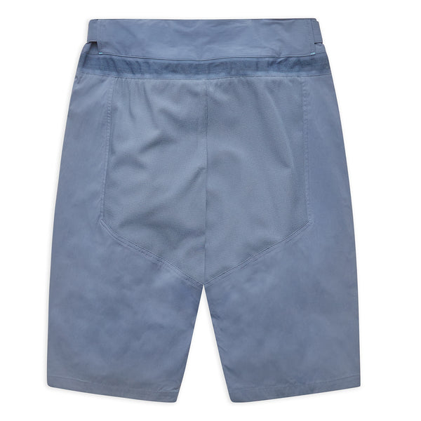 flat lay of back of blue mountain biking shorts