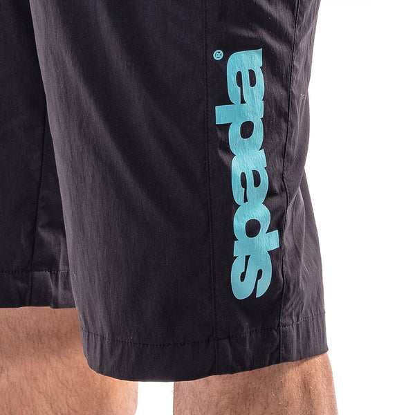 closeup of blue spada branding on a pair of black mountain biking shorts