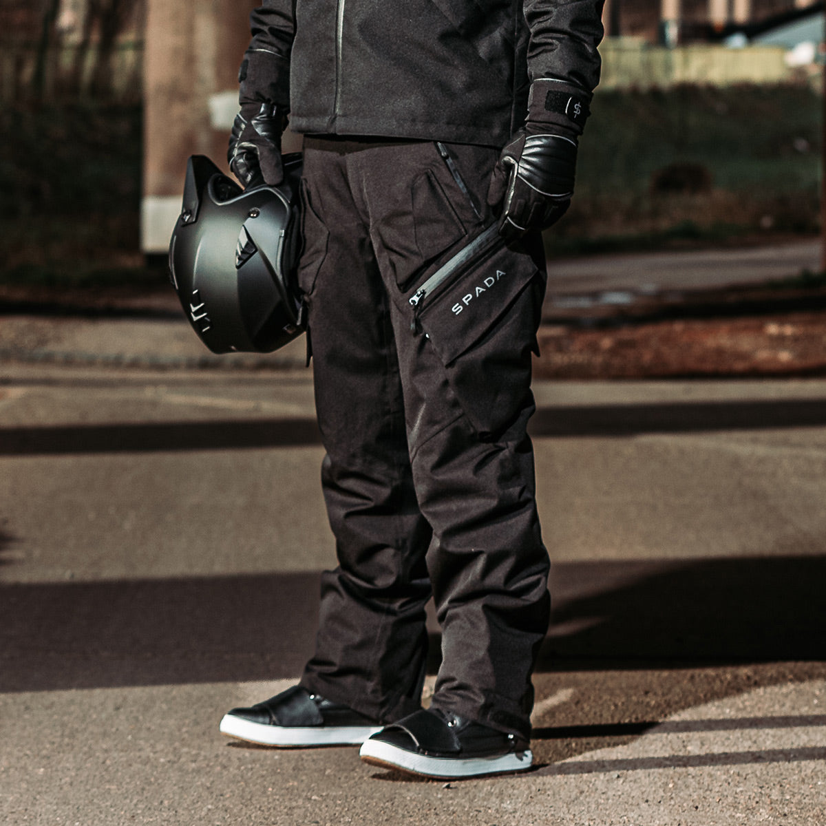 biker wearing black waterproof nodachi spada trousers with matching jacket and motorbike gear