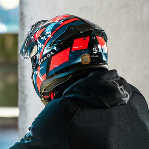 back of biker wearing spada blade hoodie and motorbike helmet with acu gold approved sticker