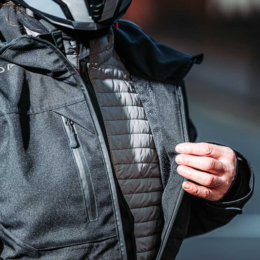 biker wearing base layer jacket under black motorcycle jacket