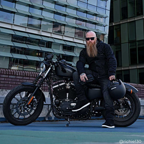 biker on motorbike wearing all black spada motorcycle gear and clothing