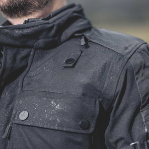 biker wearing textile jacket with water beading down