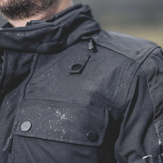 biker wearing textile jacket with water beading down