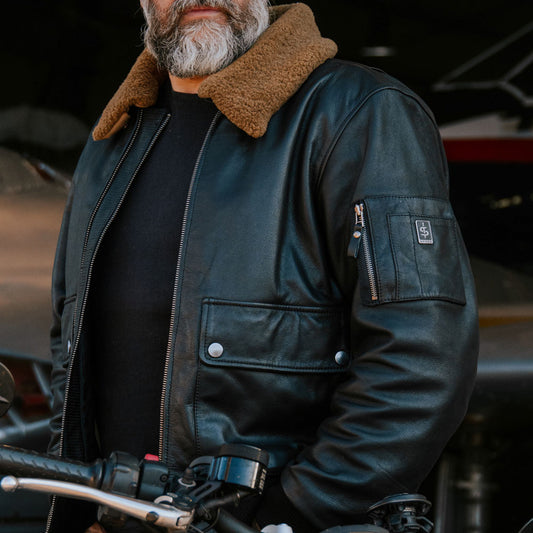 biker wearing black leather motorcycle jacket for men with faux brown collar