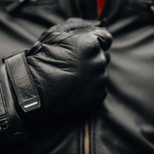 biker wearing black leather motorcycle jacket for men and matching black motorcycle gloves