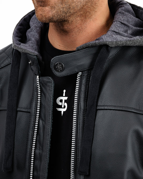Close-up of a person wearing a black leather jacket with a Spada brand logo on a white background