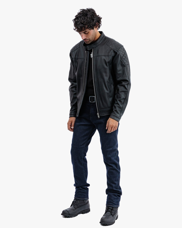 Man wearing a black leather jacket and jeans on a white background