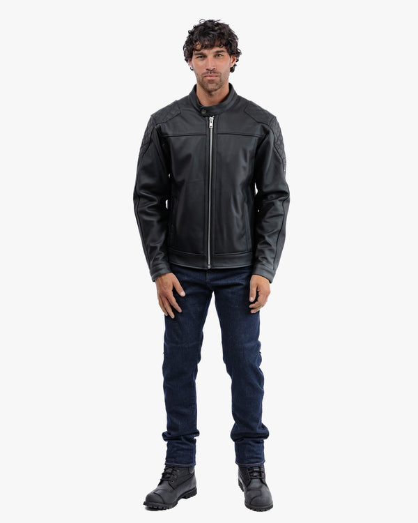 Man wearing a black leather jacket and dark jeans on a white background