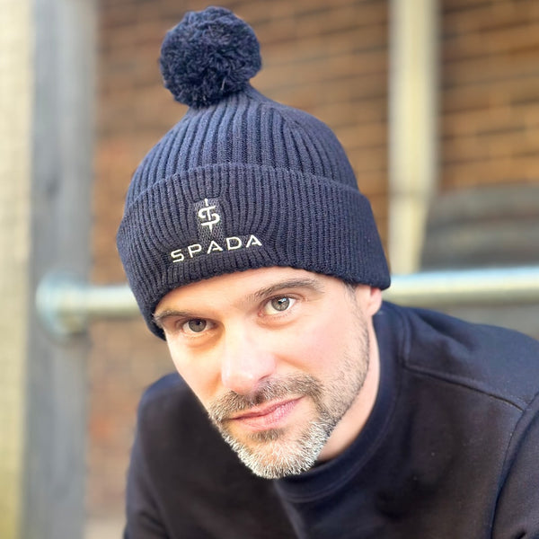 man wearing warm bobble beanie hat with detachable bobble