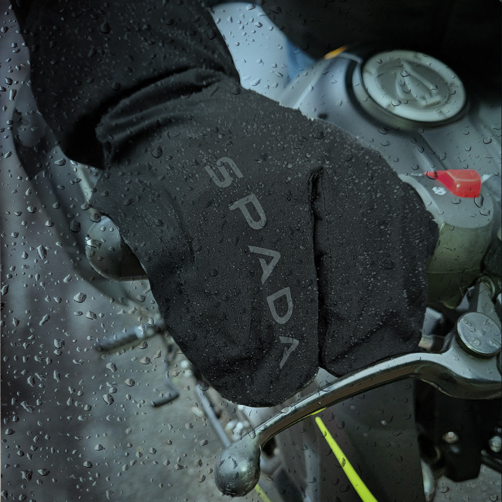 biker wearing black overmitts for motorbike riding in the rain