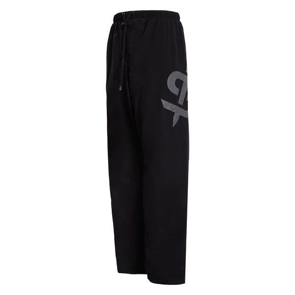 side view of black waterproof trousers with spada logo on the side