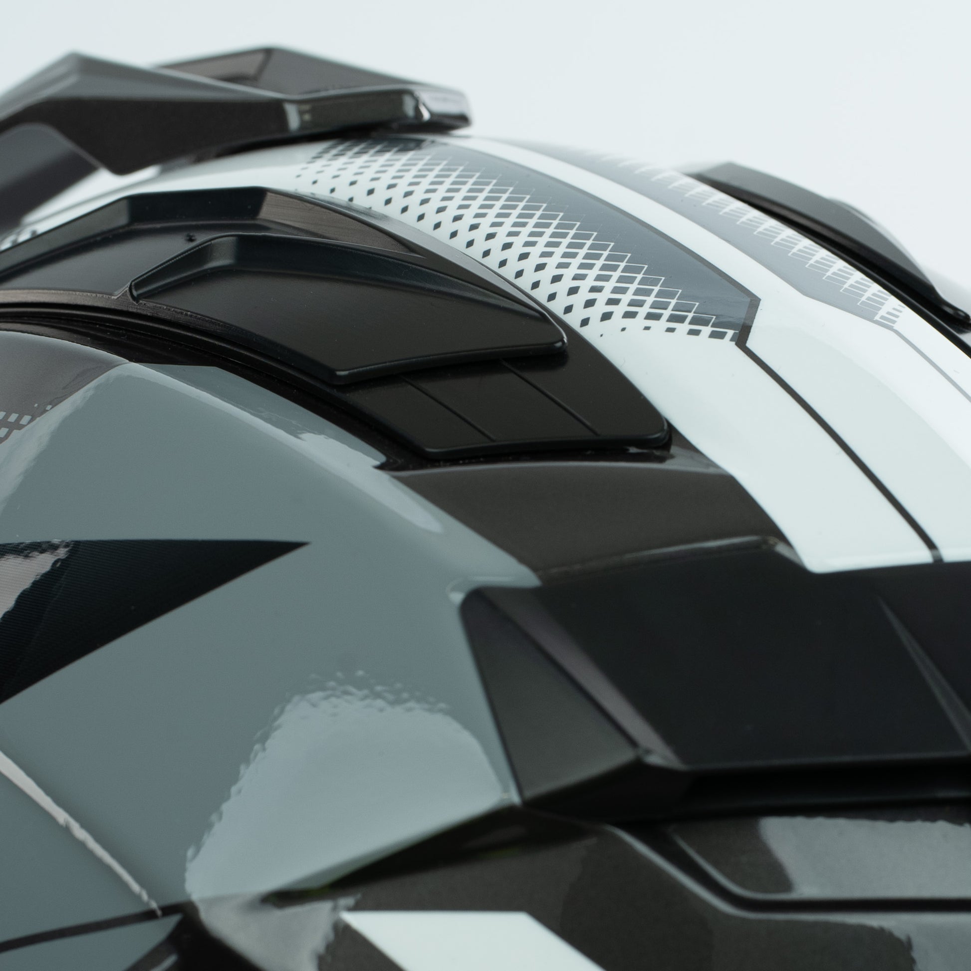 Close-up of a black and gray motorcycle helmet with reflective surface