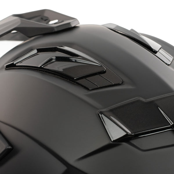 Close-up of a black motorcycle helmet with reflective visor