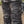 Close-up of biker wearing Crossguard trousers, showing front slant pockets and secure waist fastening