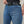 woman wearing blue biker jeans with black belt