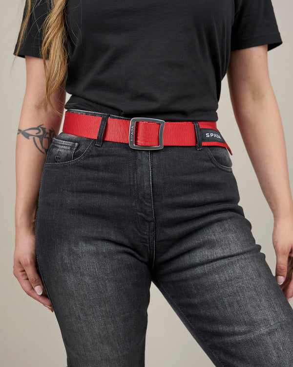 women's black motorcycle jeans with a red spada belt and silver buckle