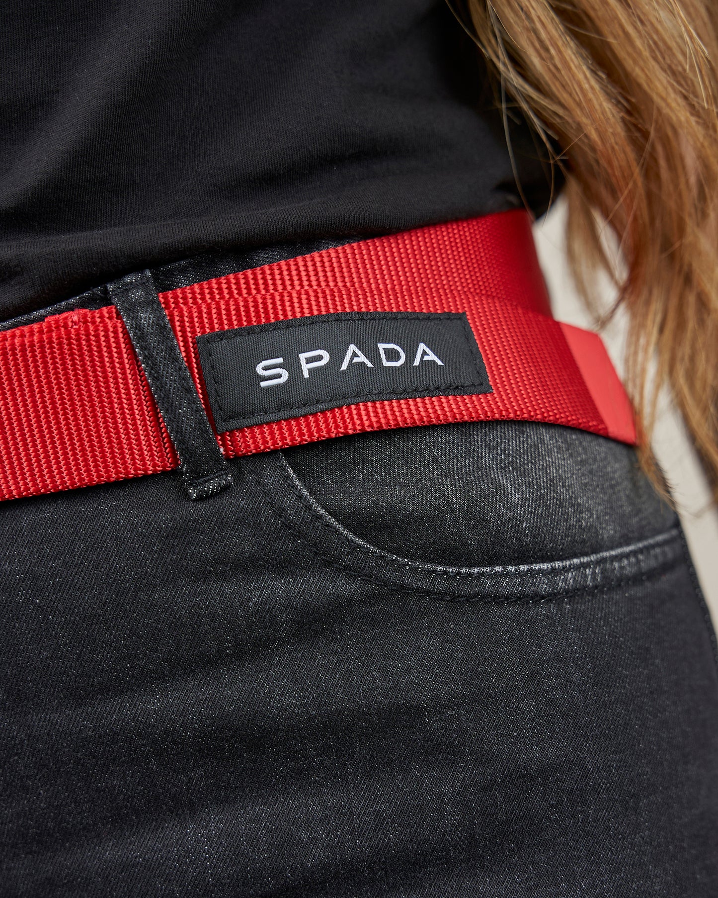 Red belt with Spada logo on a black garment