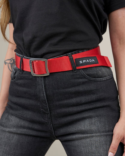 woman wearing black biker jeans with red belt with spada branding