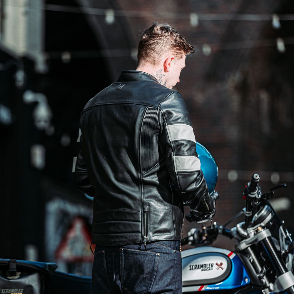 back of biker wearing black motorcycle jacket