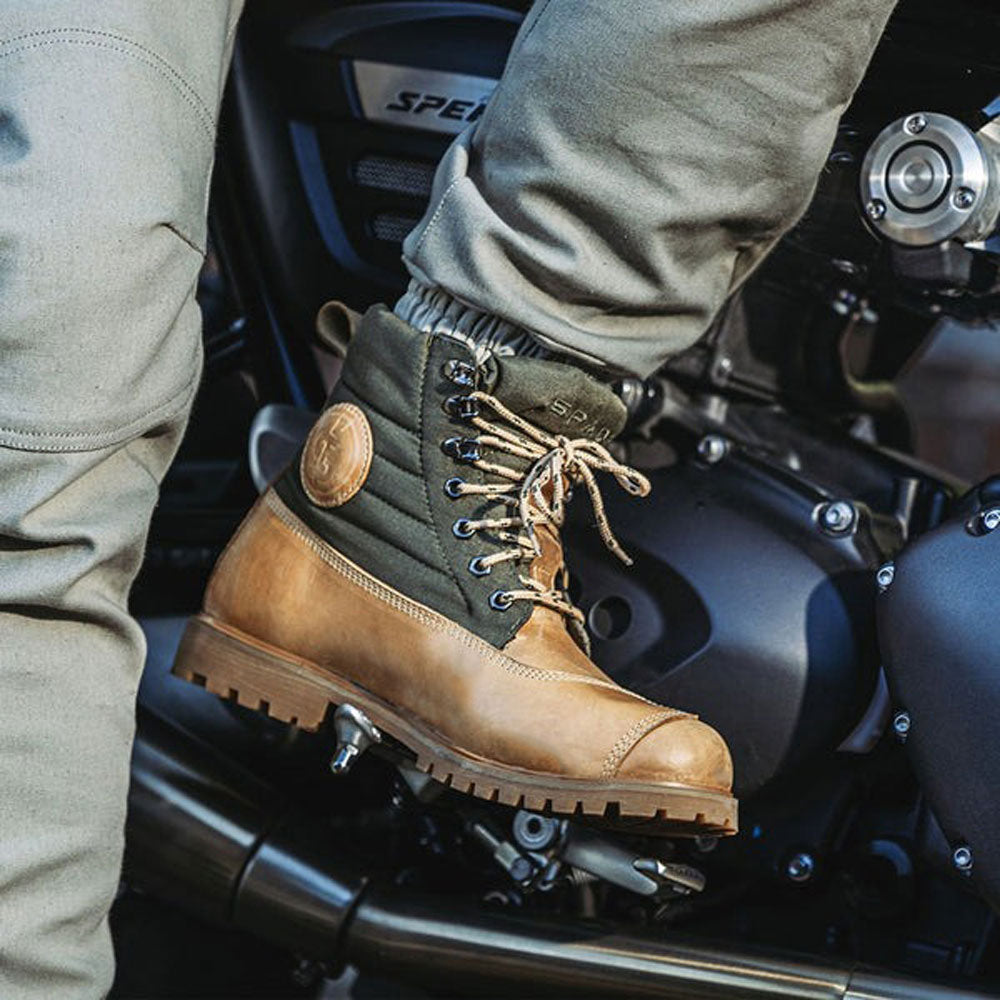 close up of biker wearing motorcycle boots on ride