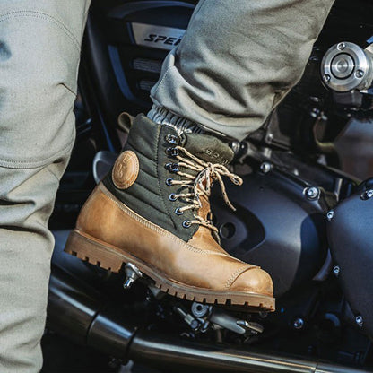 close up of biker wearing motorcycle boots on ride