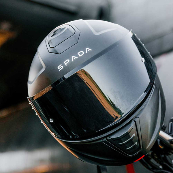 closeup of matte black motorbike helmet on motorbike