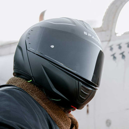 biker wearing black motorcycle helmet in matte black for men 