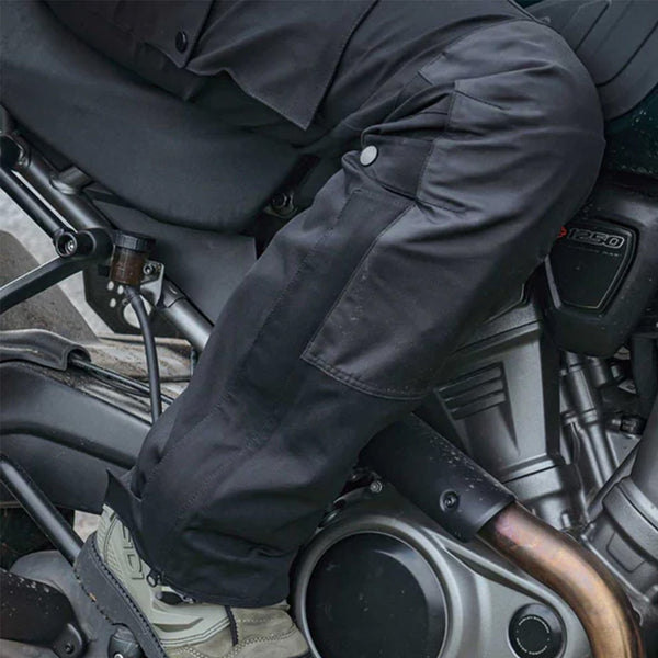 closeup of leg of biker wearing waterproof black biker trousers