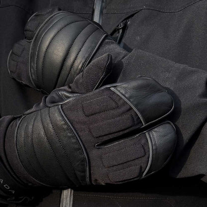 closeup of biker wearing black lobster claw motorcycle gloves