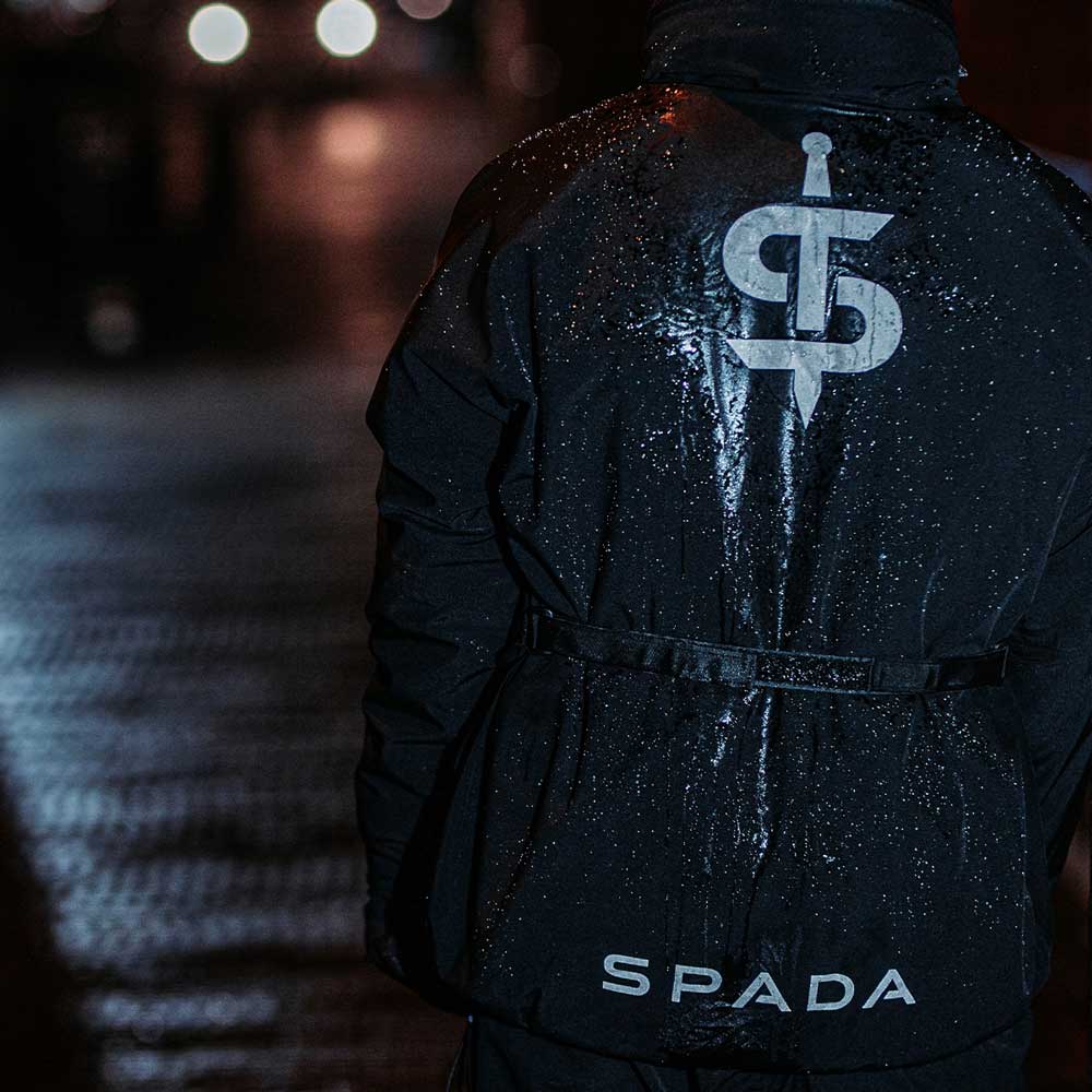 biker wearing black reflective motorcycle jacket in the rain