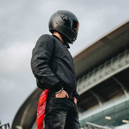 biker wearing full black motorcycle gear including black motorcycle bomber jacket and black motorcycle jeans