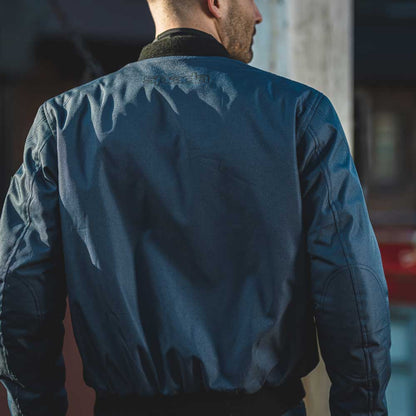 back of biker wearing navy blue motorcycle jacket for men