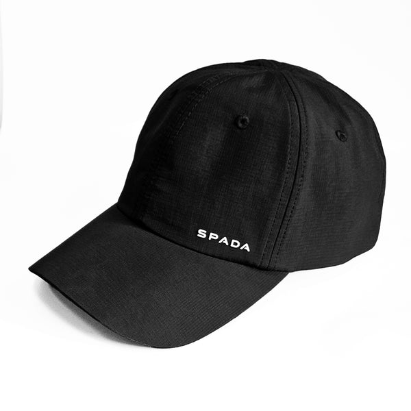 A black Spada City Soft Shell Cap with a curved brim and an adjustable strap.