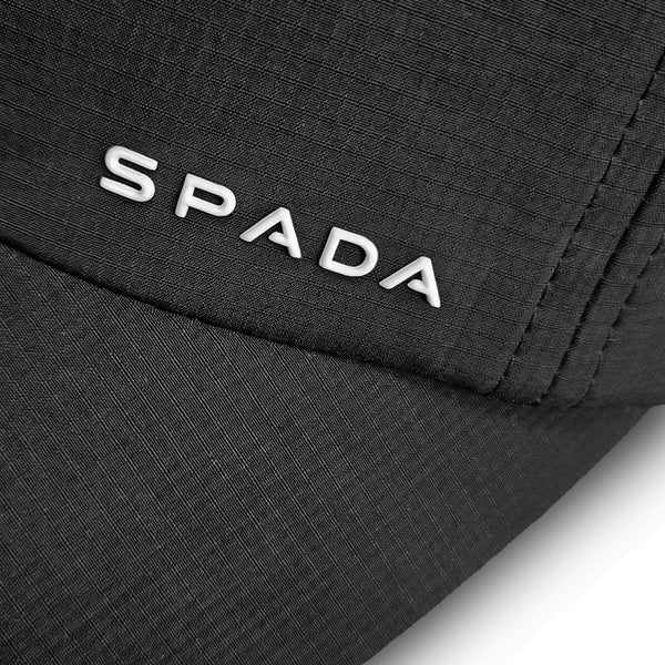 closeup of white spada logo on black soft shell cap