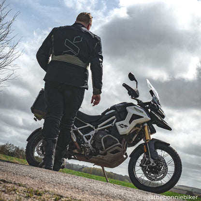 back of black and green motorcycle jacket for men worn by biker with white and black motorbike