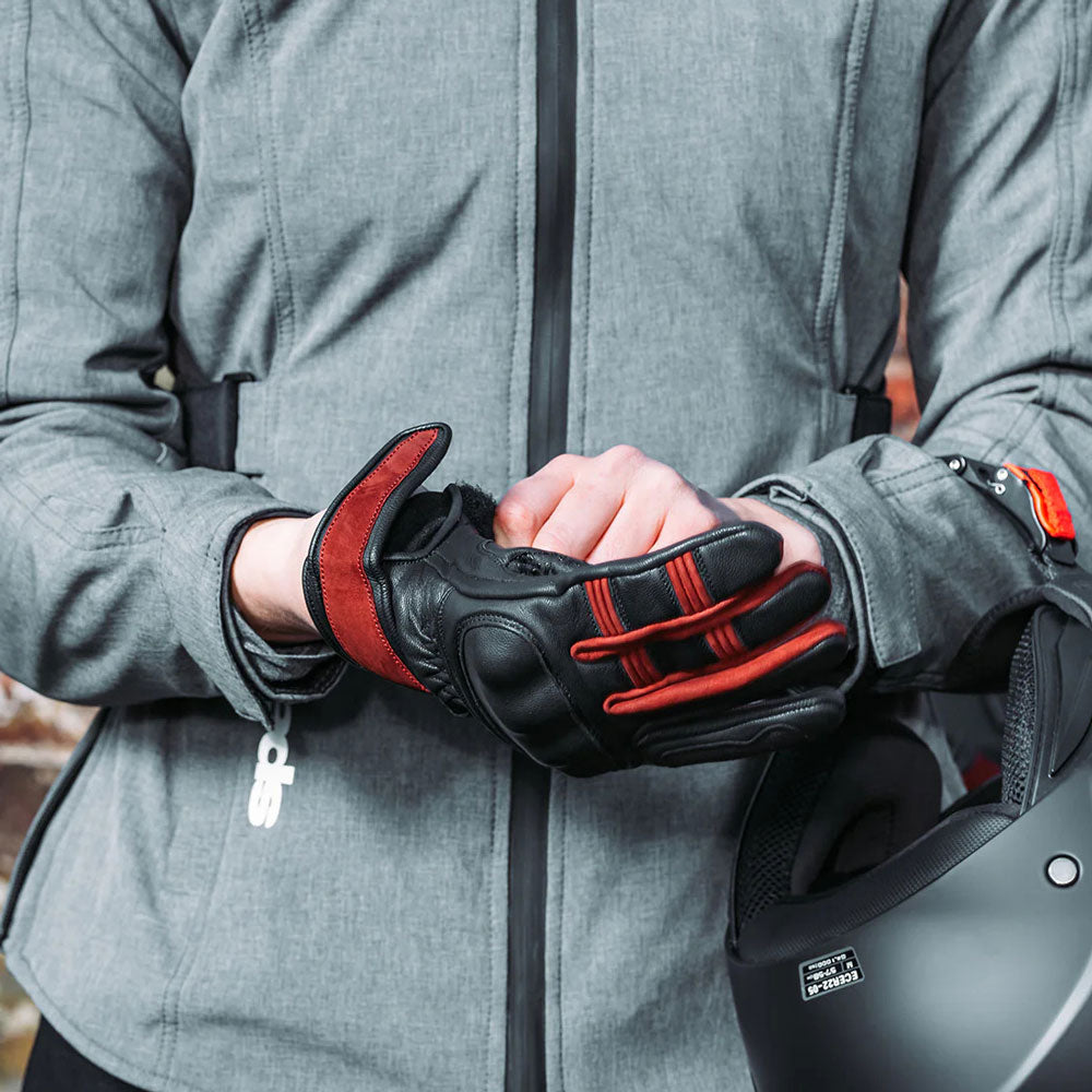 woman wearing black and red motorcycle leather gloves with silicone print on palm