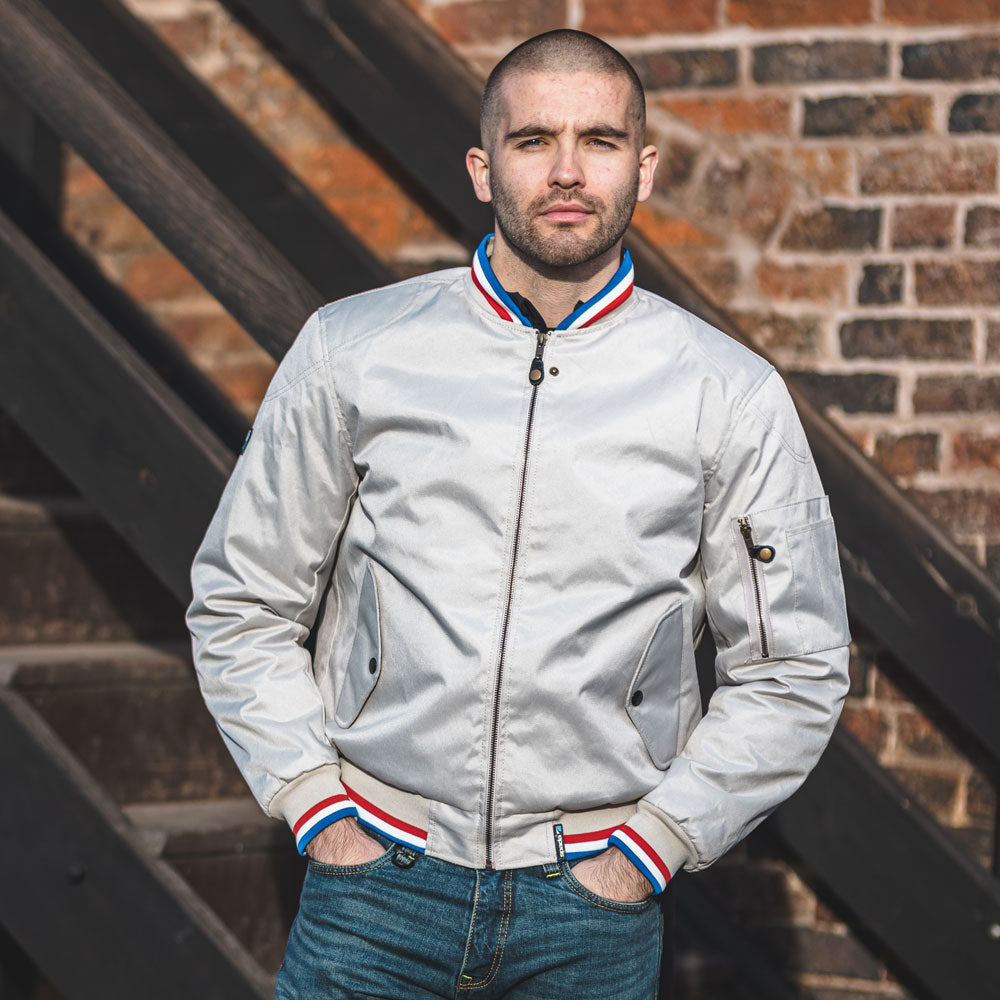 model wearing mens cream ivory motorcycle bomber jacket inspired by aviation heritage