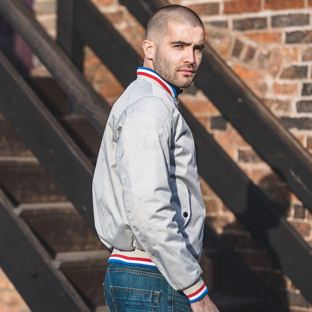 side details of model wearing bomber jacket for motorcycle riding in cream