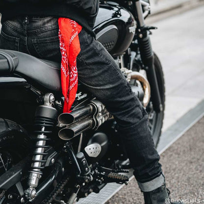 biker on motorbike wearing black motorcycle jeans for men with motorcycle gear