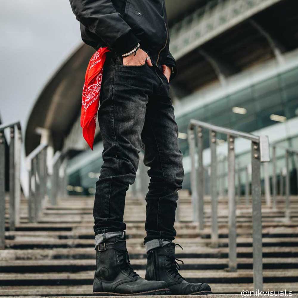 biker wearing black motorcycle jeans with black motorbike boots for men