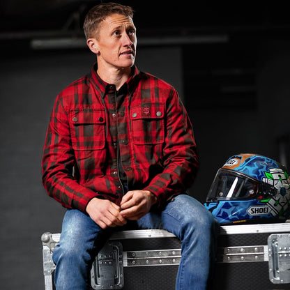 dean harrison wearing black and red checkered motorcycle shirt with blue shoei helmet