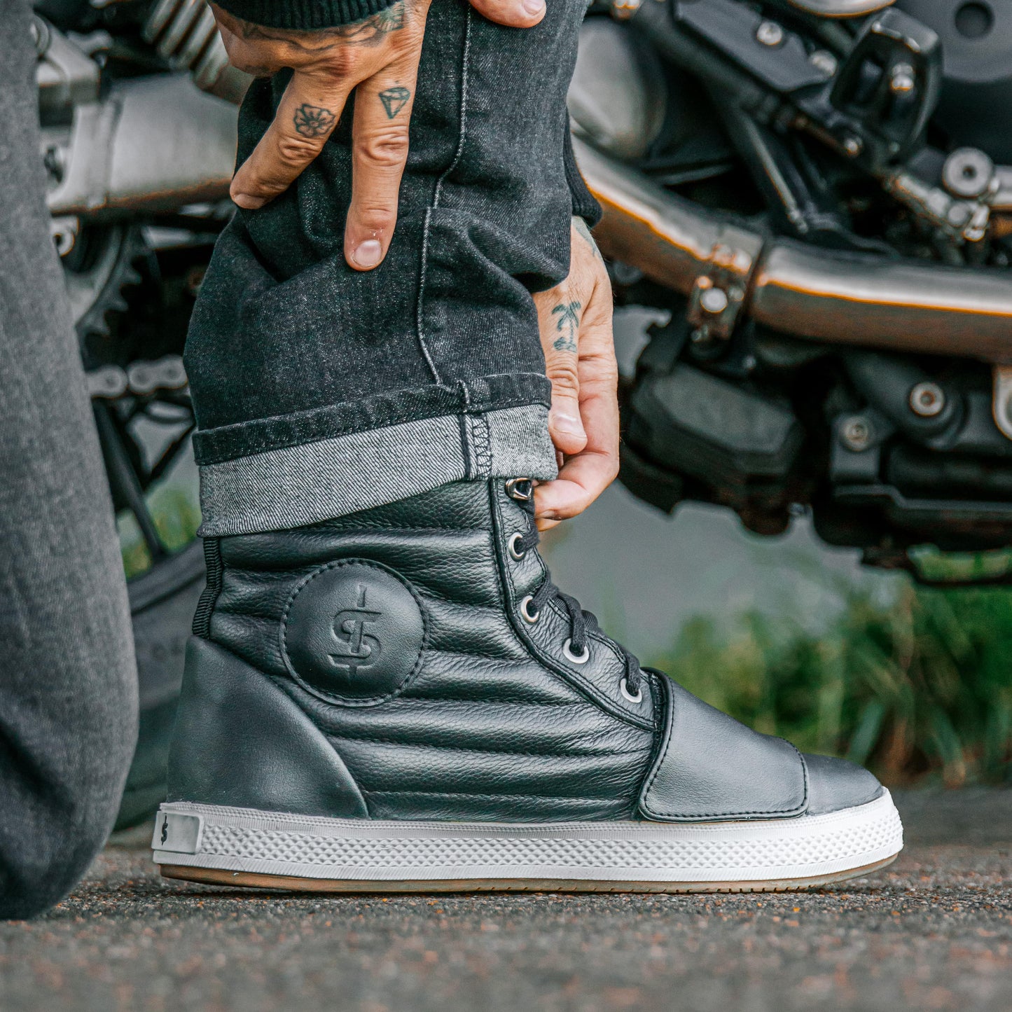 biker wearing black motorcycle jeans with black motorcycle boots on bike ride