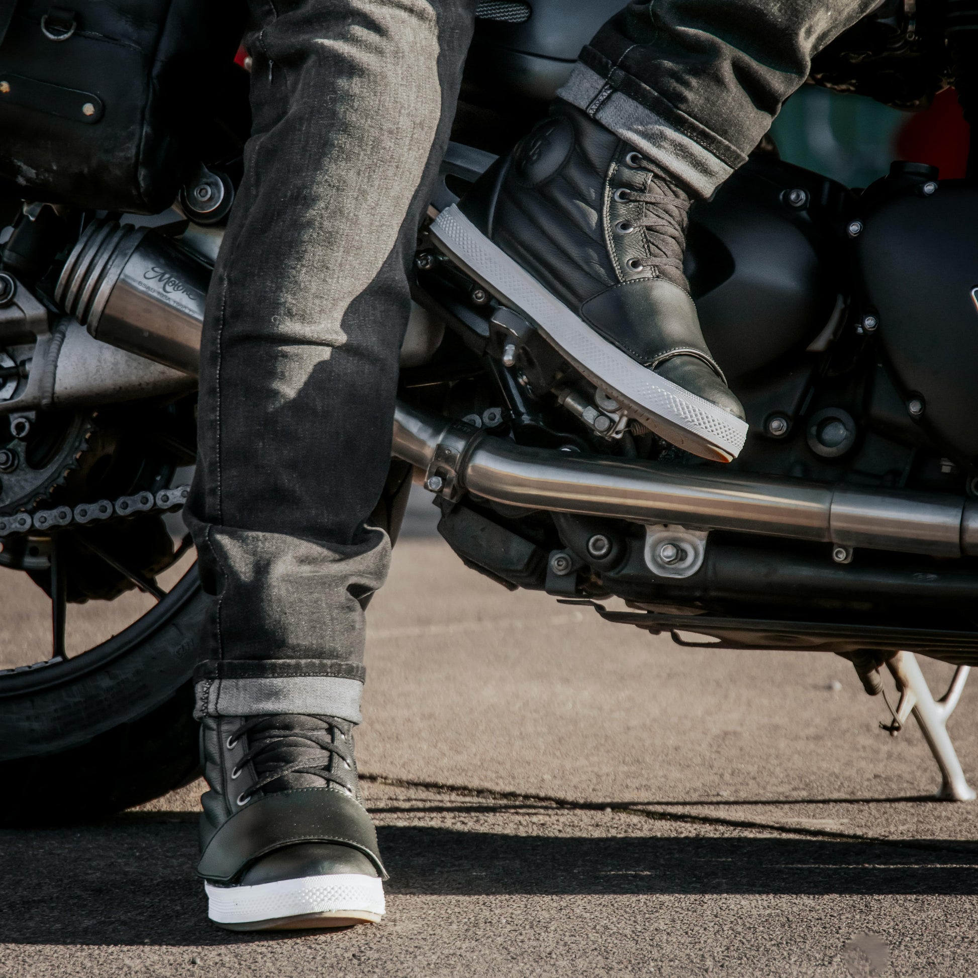 biker wearing black high top trainers with black motorcycle jeans