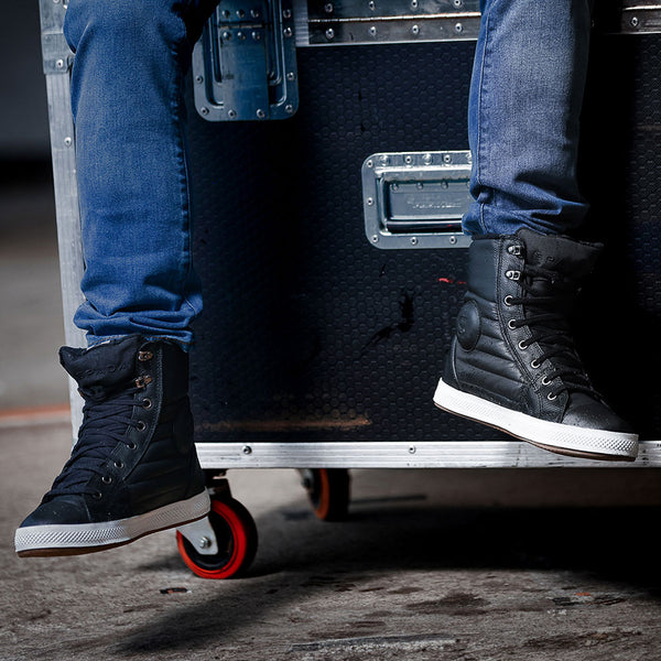 TT racer Dean Harrison wearing Heat Black motorcycle trainers with jeans