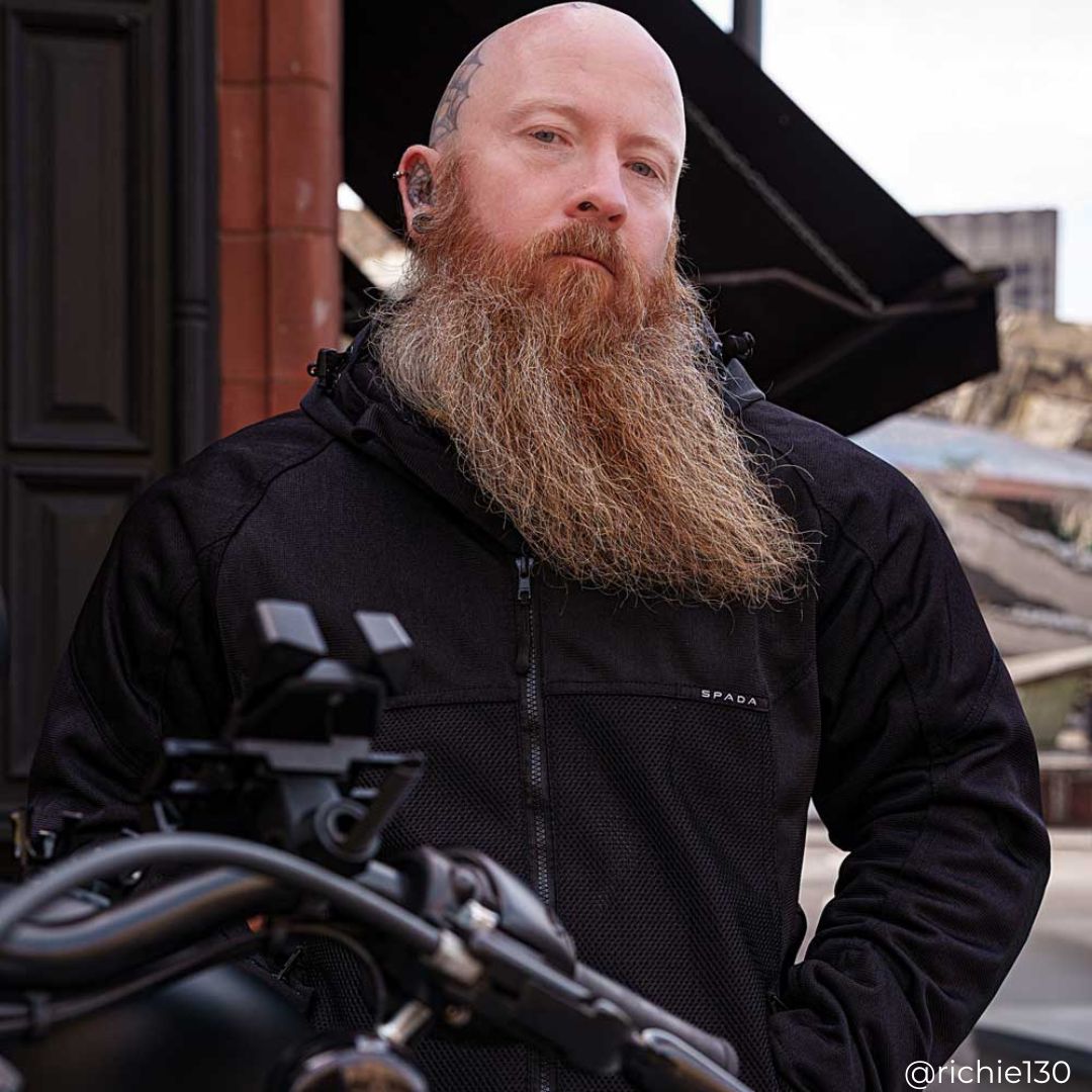 biker wearing black motorcycle jacket for men on motorbike