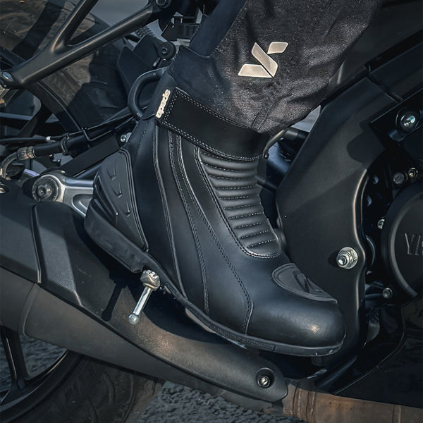 closeup of biker on motorbike wearing icon motorbike boots