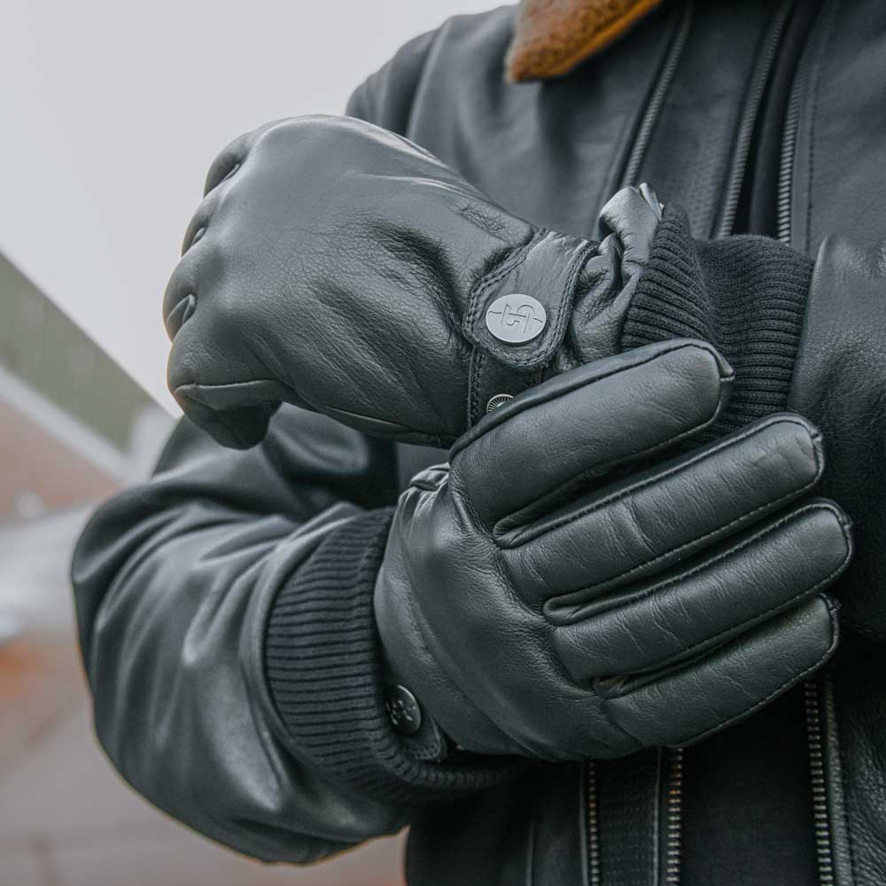 biker wearing black leather motorcycle jacket for men with black leather motorcycle gloves