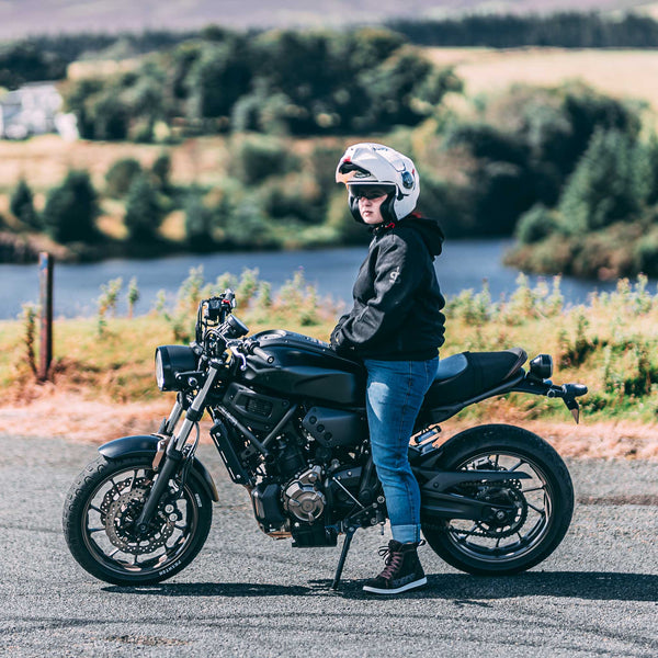 Woman biker on motorcycle wearing Drifters womens washed blue motorcycle jeans – casual fit with riding protection