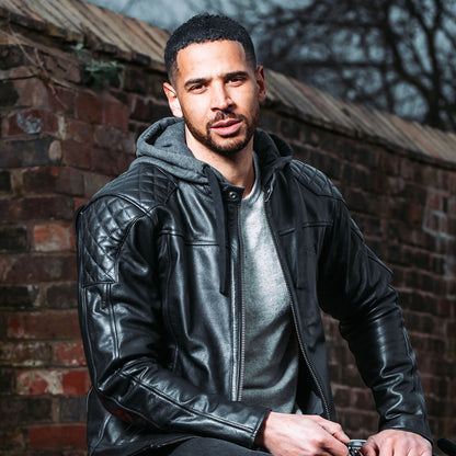 man wearing black leather motorcycle jacket unzipped with quilted design on shoulders